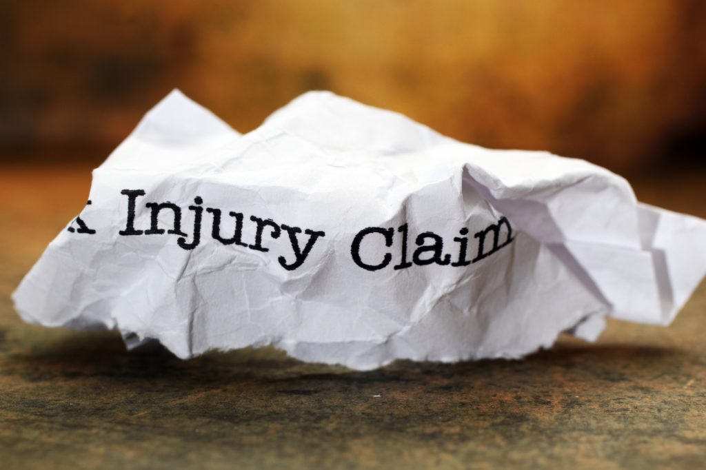 Wadded up piece of paper that says personal injury claim as part of a Mold Injury